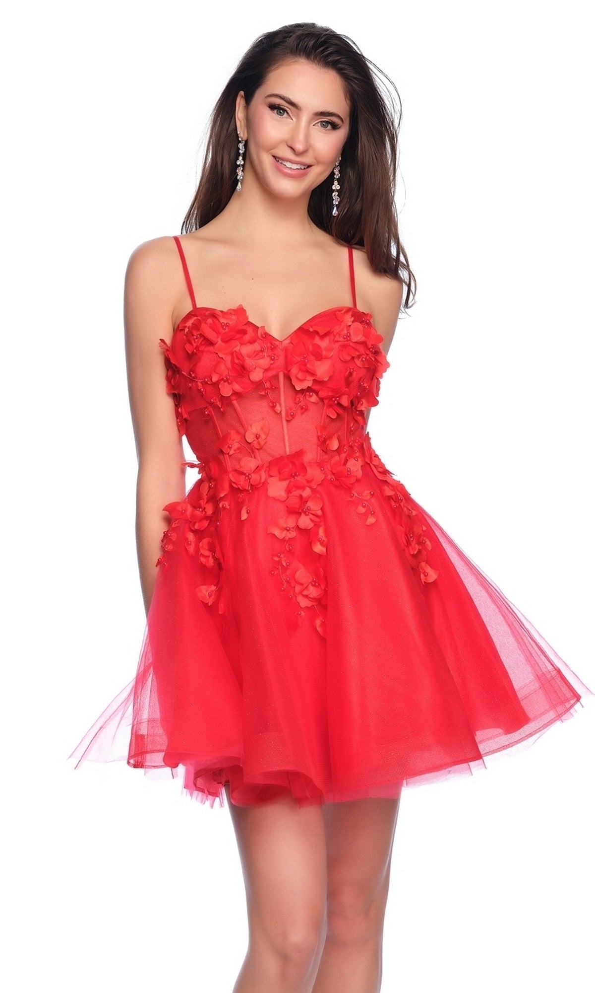Woman wearing the Dave and Johnny Short Red Floral Hoco Dress 11726, featuring a floral-accented tulle skirt, corset bodice, and spaghetti straps, poses and smiles at the camera.